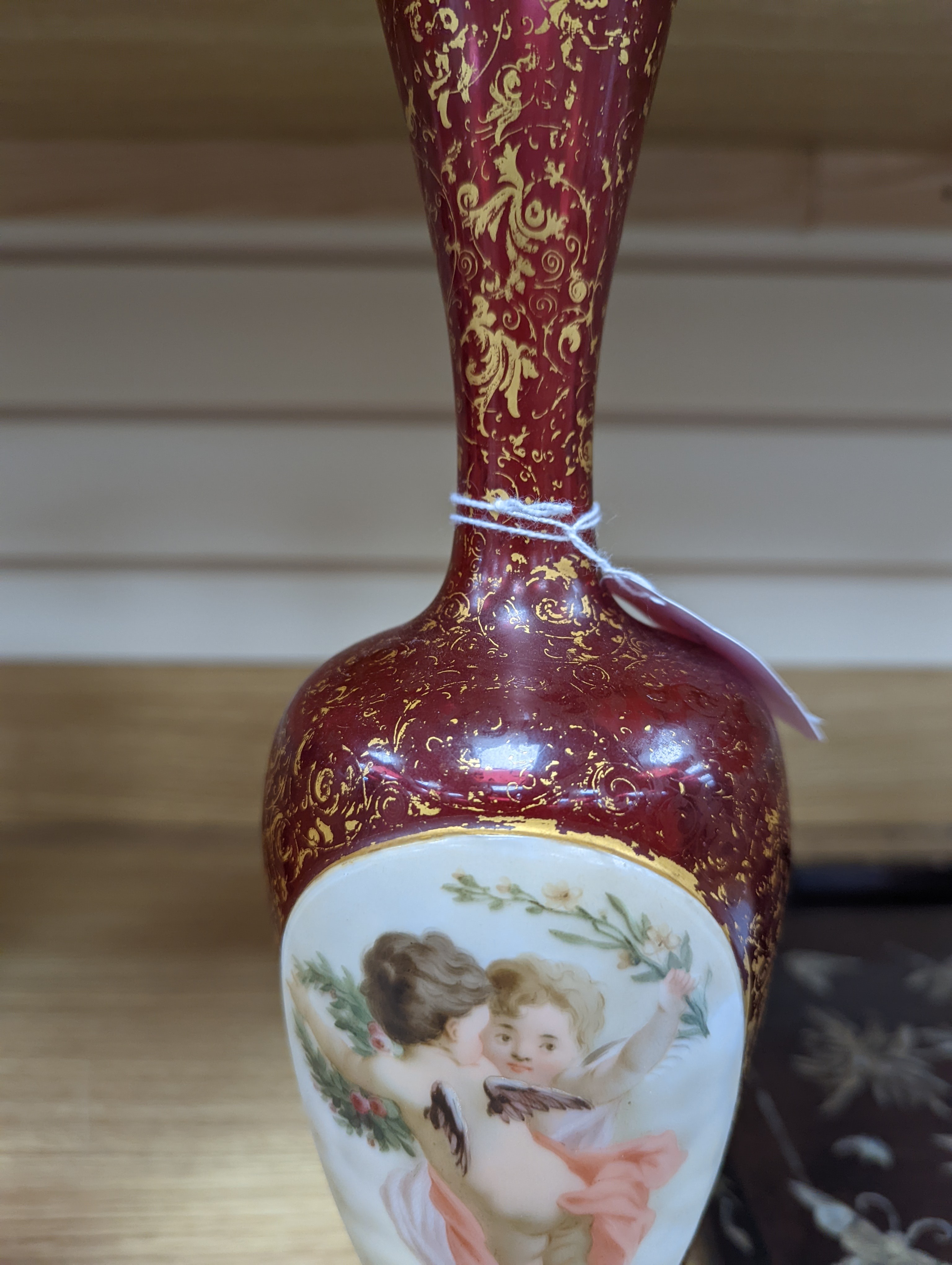 A pair of 19th century Bohemian enamelled and overlaid ruby glass vases 36cm